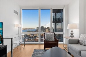 Smart TV - Chic 1BR | Laundry + Kitchen | Midtown West (New York)