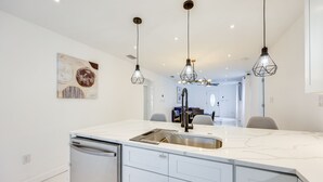A modern kitchen with a marble countertop, stainless steel sink, and pendant lighting. - Pet-Friendly St Augustine Home: 2 Mi to Downtown! (St. Augustine)