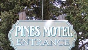 A sign for Pines Motel Entrance. - Pines Motel (Hinton)
