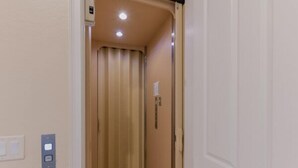 A narrow hallway with a door leading to a room. There are light switches on the wall and a small sign above the door. - Prentiss Pointe Condo - 3 bedroom, 2 bath, 2-Floor Condo in Ft Myers (Fort Myers)