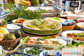 A buffet with various dishes, including noodles, salads, and fruits. - Kurobe view hotel (Omachi)