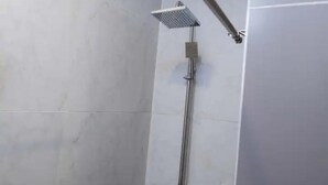 A shower with a handheld showerhead mounted on a wall. - Canalily Apt

 (Lekki)