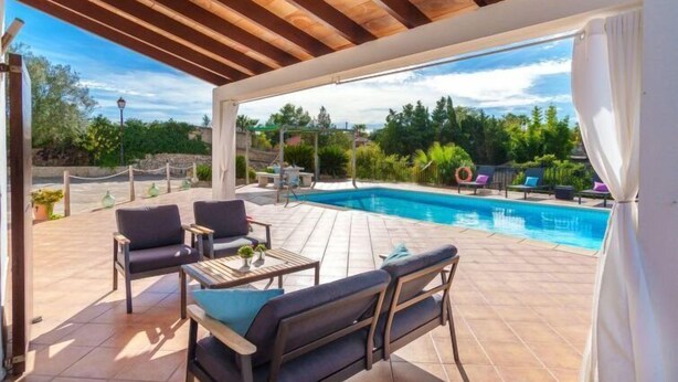 A covered outdoor area with a pool, seating, and a view of the surrounding landscape. - Son Alcaines Sineu by Interhome (Sineu)