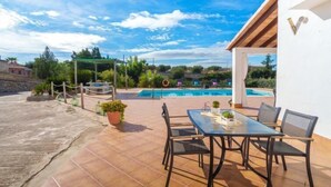 A patio with a pool, outdoor seating, and a view of the surrounding landscape. - Son Alcaines Sineu by Interhome (Sineu)