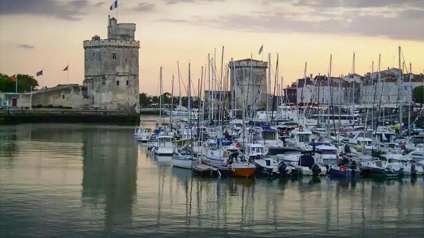 A marina with numerous boats docked, a historic tower, and a calm waterfront setting. - Amazing (sta)caravan in CHEF-BOUTONNE (CHEF-BOUTONNE)