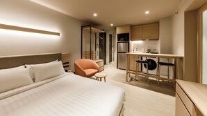 A modern hotel room with a large bed, a desk, and a kitchenette. - Nishitetsu Hotel Croom Bangkok Silom (Bangkok)