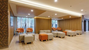 A modern waiting area with seating arrangements and large windows. - Nishitetsu Hotel Croom Bangkok Silom (Bangkok)