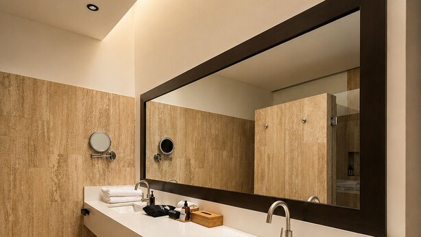A modern bathroom with a long vanity, two sinks, a large mirror, and wooden wall panels. - Hotel Flores de Sal (Valle de Guadalupe)