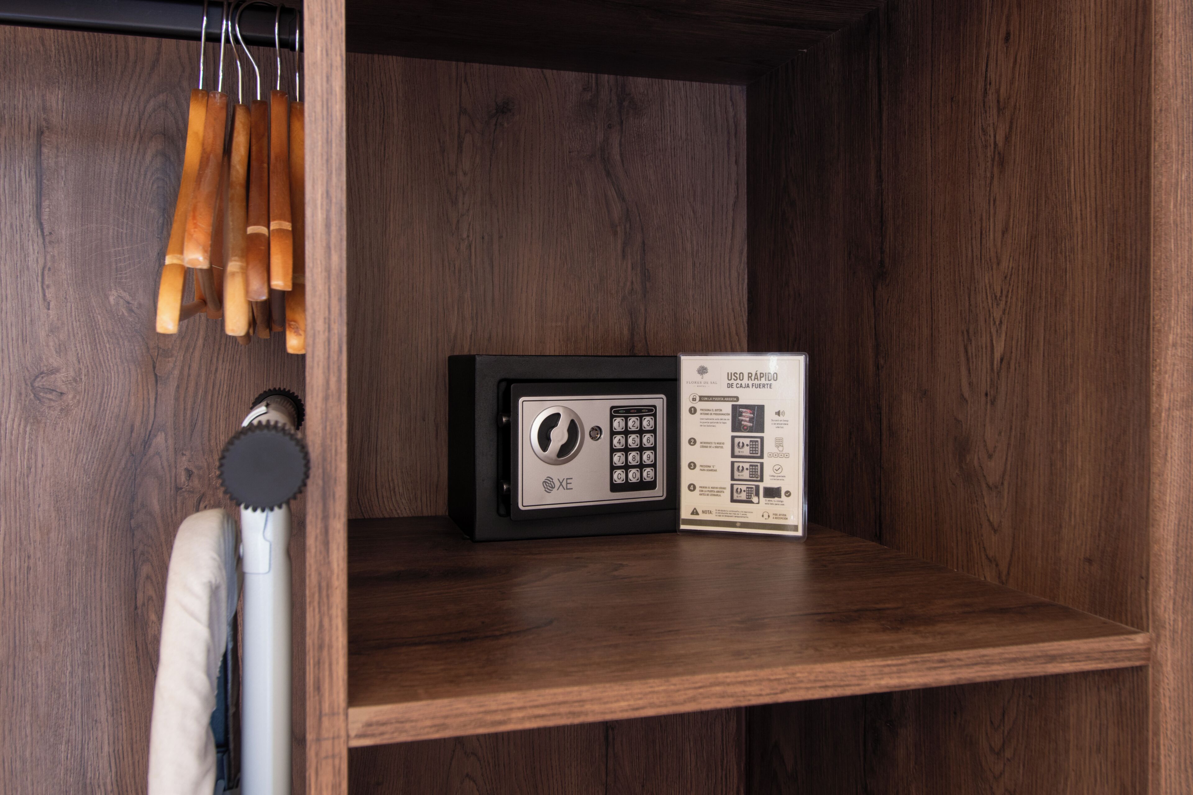 A wooden shelf with a safe and a set of keys.