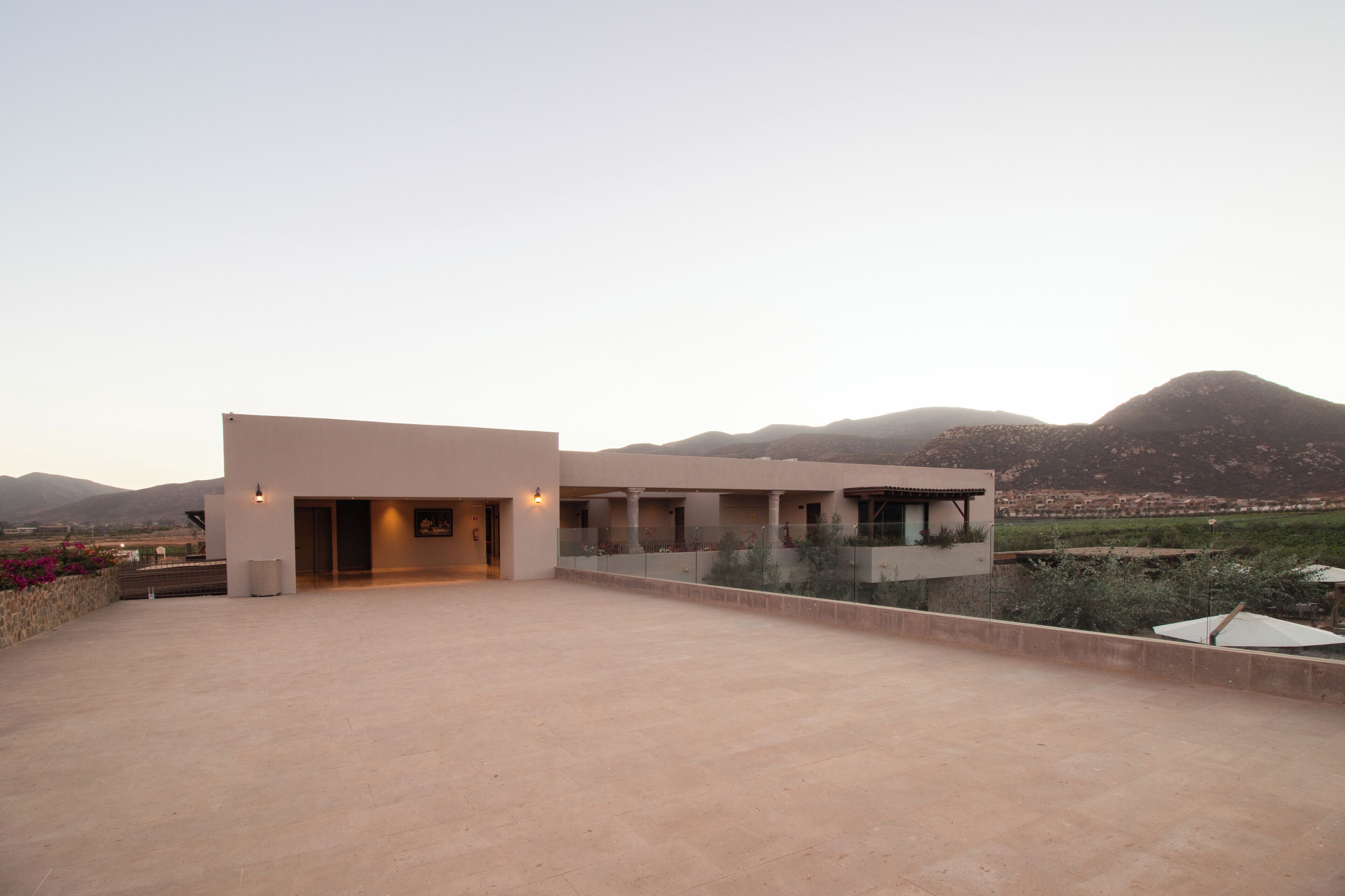 A modern building with a flat roof and a large open terrace.