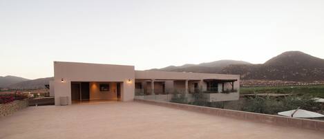 A modern building with a flat roof and a large open terrace.