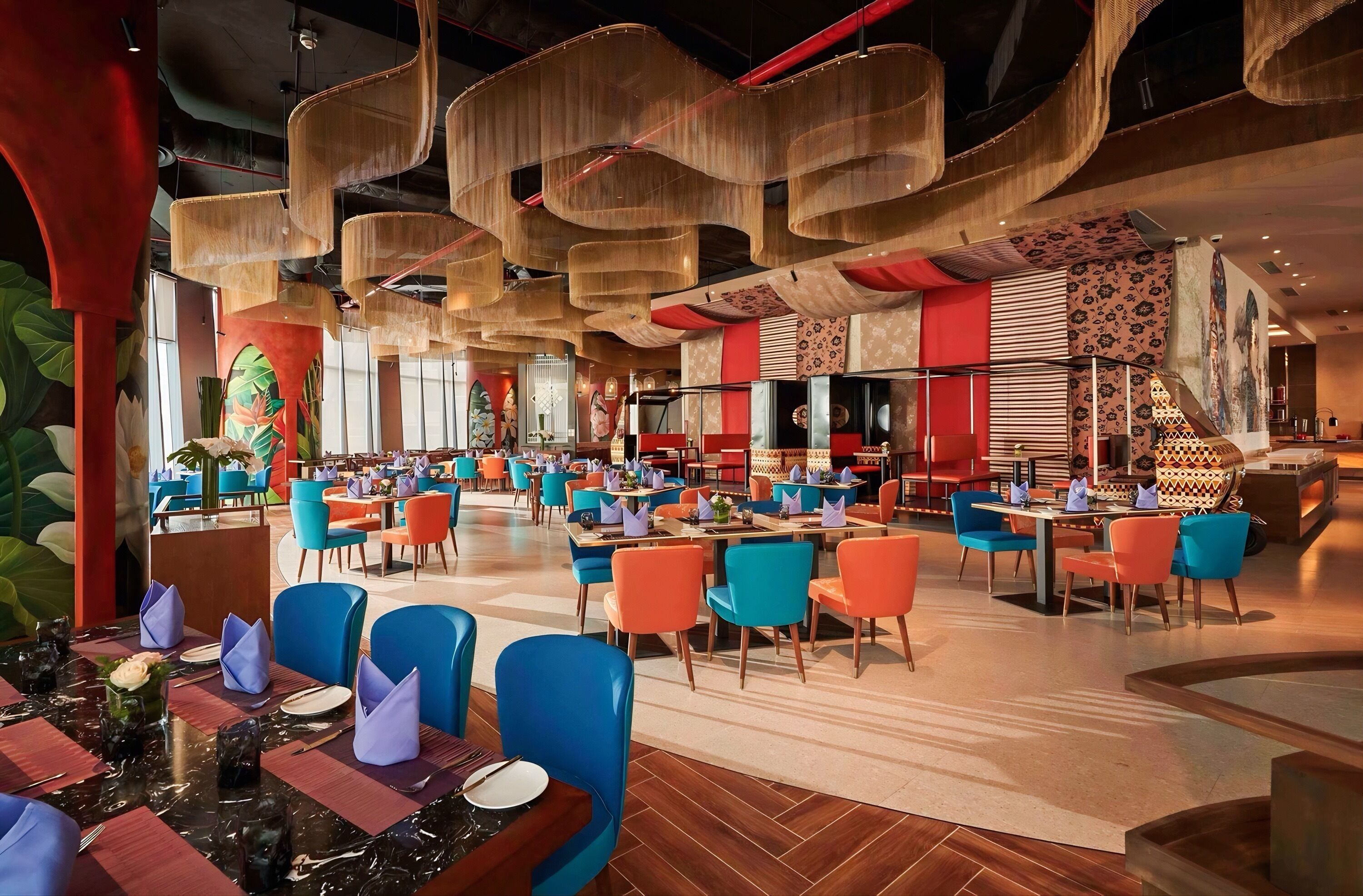 A spacious restaurant with high ceilings, modern chairs, and a variety of seating arrangements.