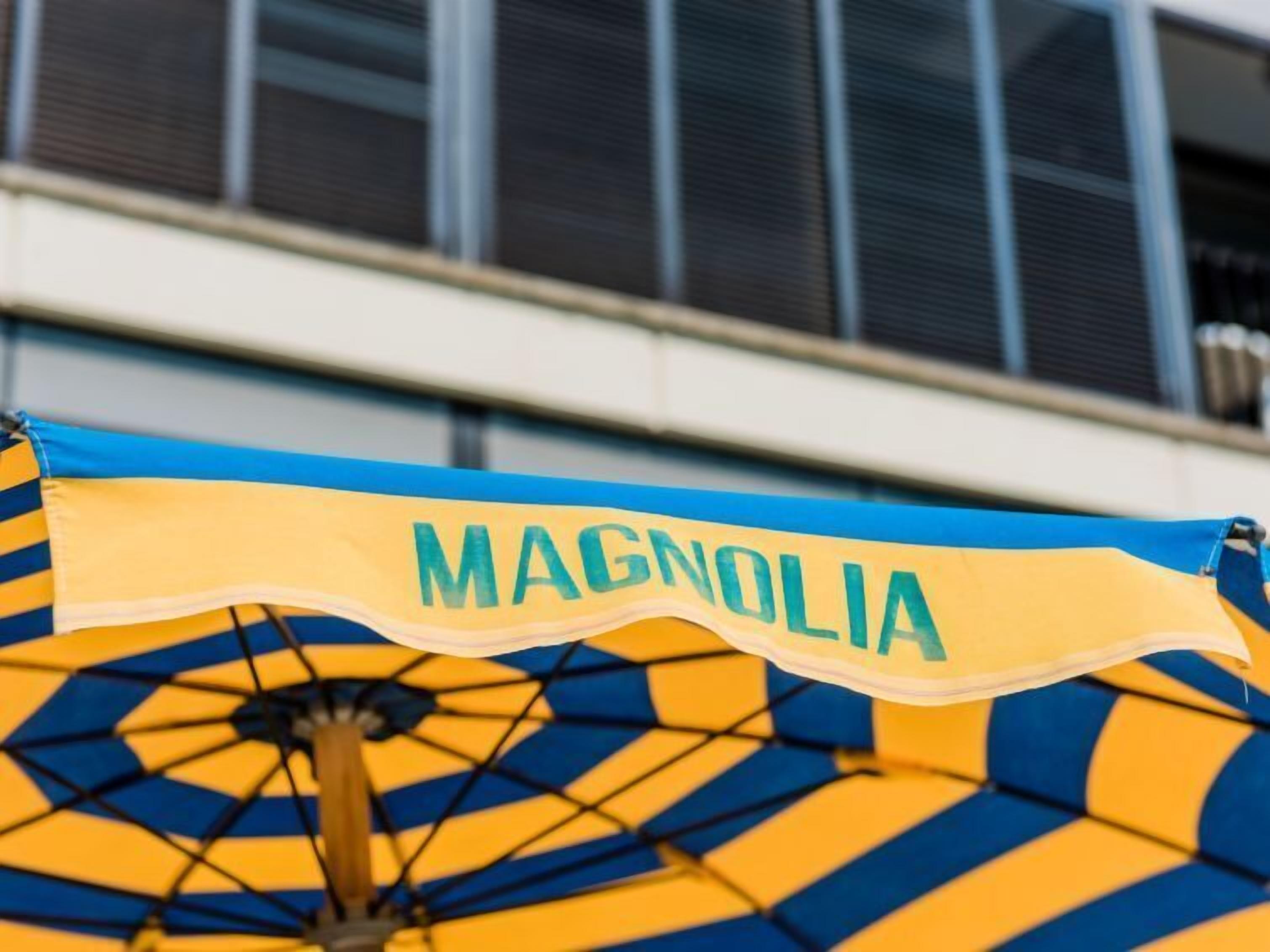 An umbrella with the word "MAGNOLIA" on it.
