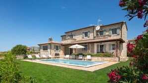 A two-story stone house with a swimming pool, outdoor seating, and a well-maintained lawn. - Rorripa by Interhome (Poreč/Sv. Lovreč)
