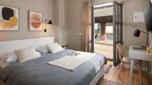 A modern bedroom with a large bed, a desk, and a view of the outside. - Calluna by Interhome (Poreč/Sv. Lovreč)