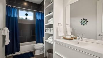 Shower, hair dryer, towels, shampoo