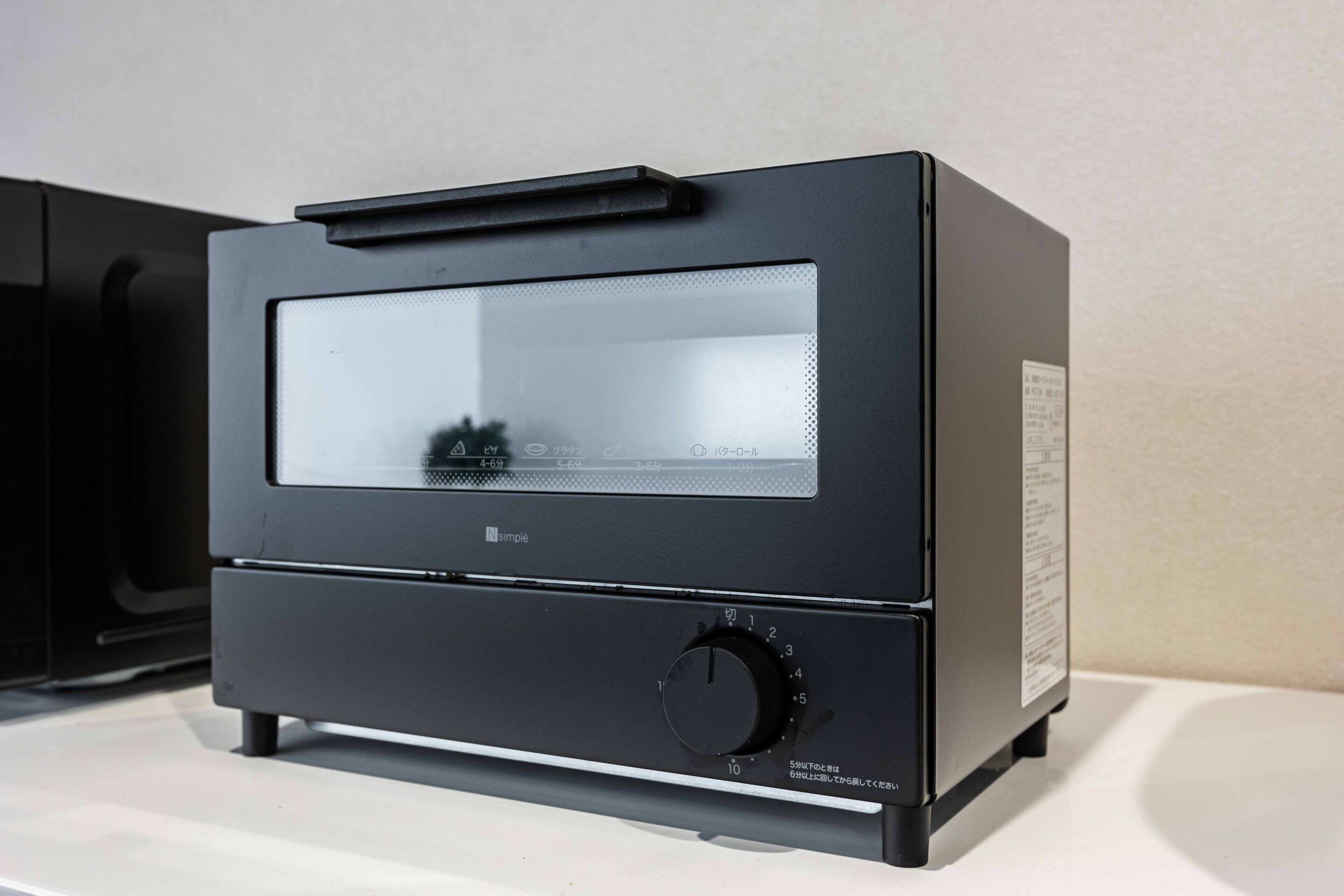 A black audio equipment with a control knob and a display screen.