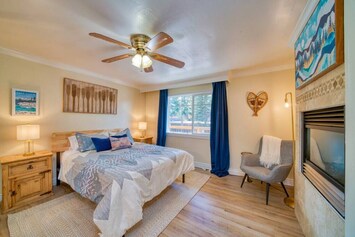 Master bedroom equipped with queen size bed and gas fire place, along with the attached master bathroom.