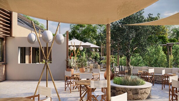 An outdoor patio area with wooden furniture, a stone planter, and a pergola with hanging spherical lights. - Poolside Escape with Sauna (Voorthuizen)
