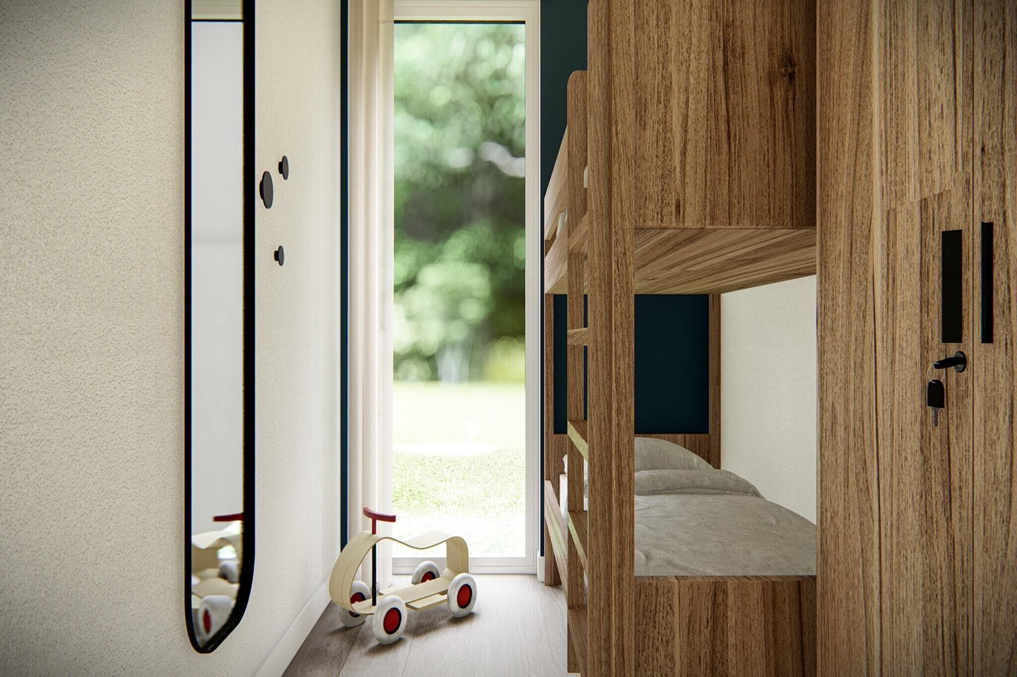A bedroom with a bunk bed, a wooden wardrobe, a mirror, and a toy car.