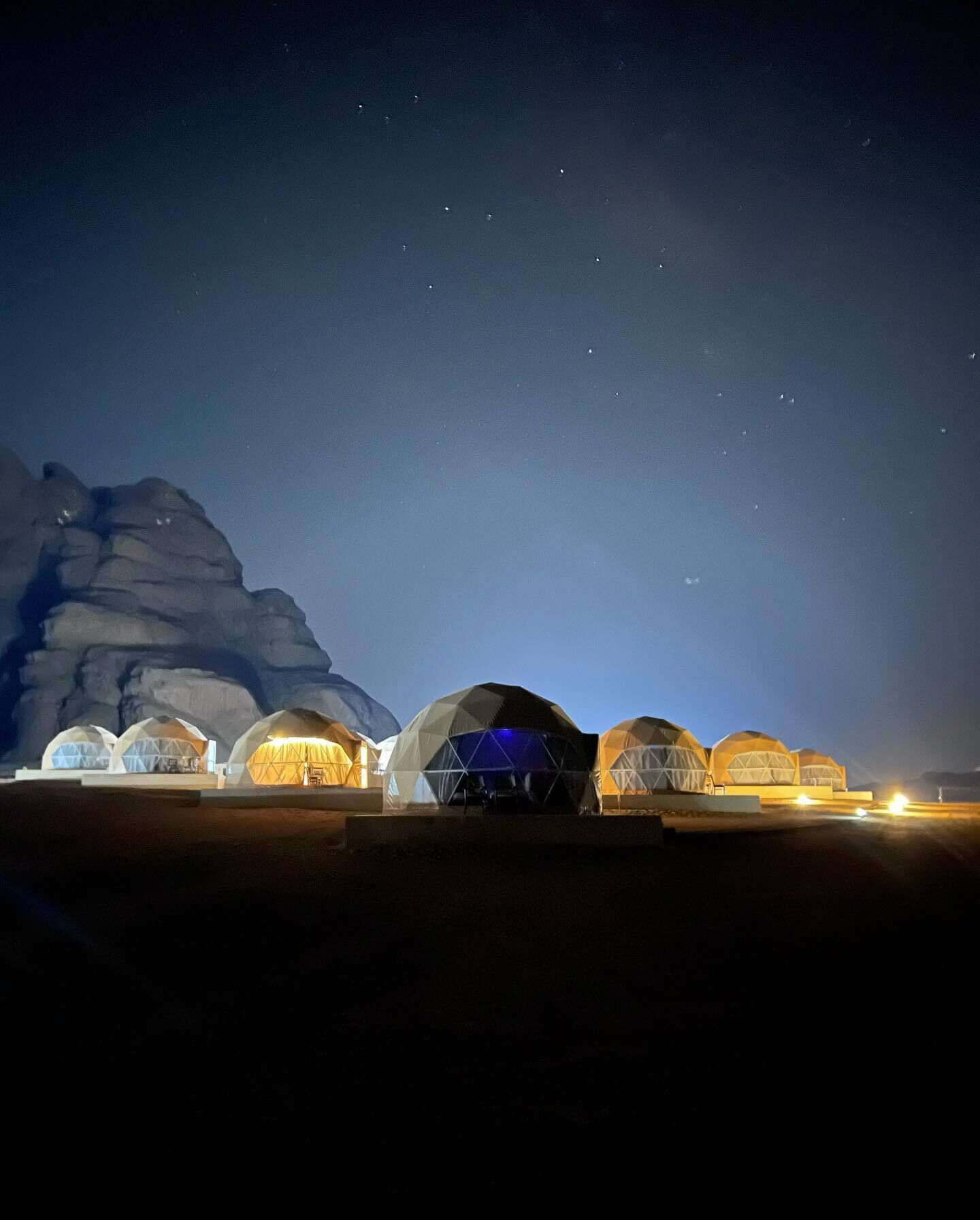 A series of dome-shaped buildings with a flat roof, arranged in a row.