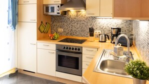 A modern kitchen with a microwave, stove, and sink. - Apartment Ritter by Interhome (Koserow)