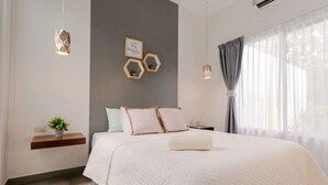 A modern bedroom with a large bed, bedside tables, a wall-mounted shelf with a plant, and a window with curtains. - Near Manuel Antonio-Private Pool-Gated-Chic-Paved road-minutes to marina (San Martin)