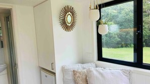A room with a window, a white wall, and a door.