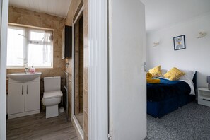 A bathroom with a sink, toilet, and shower. - Impeccable 3-bed House in Abbeywood (London)