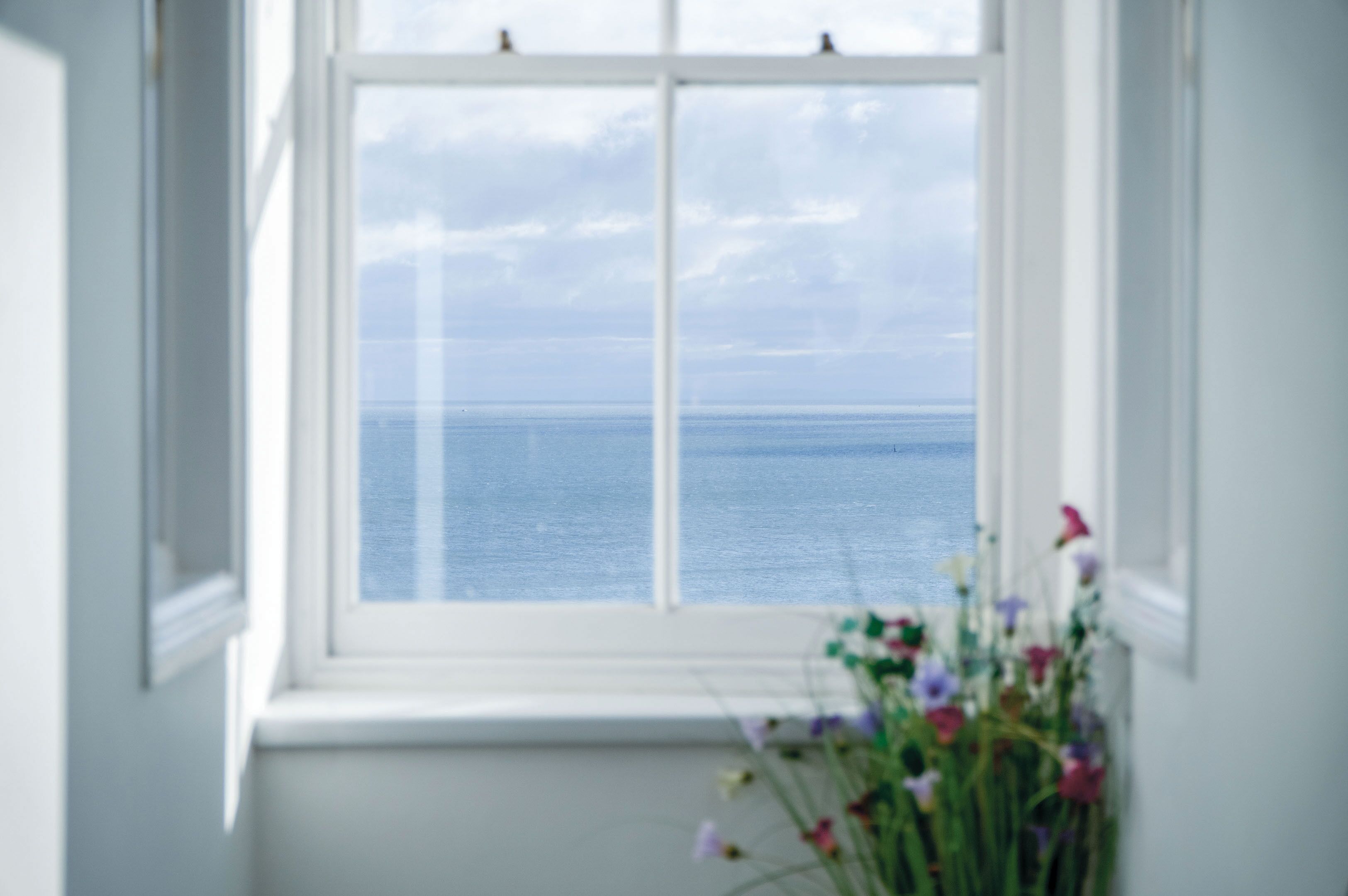 A window with a view of the sea.
