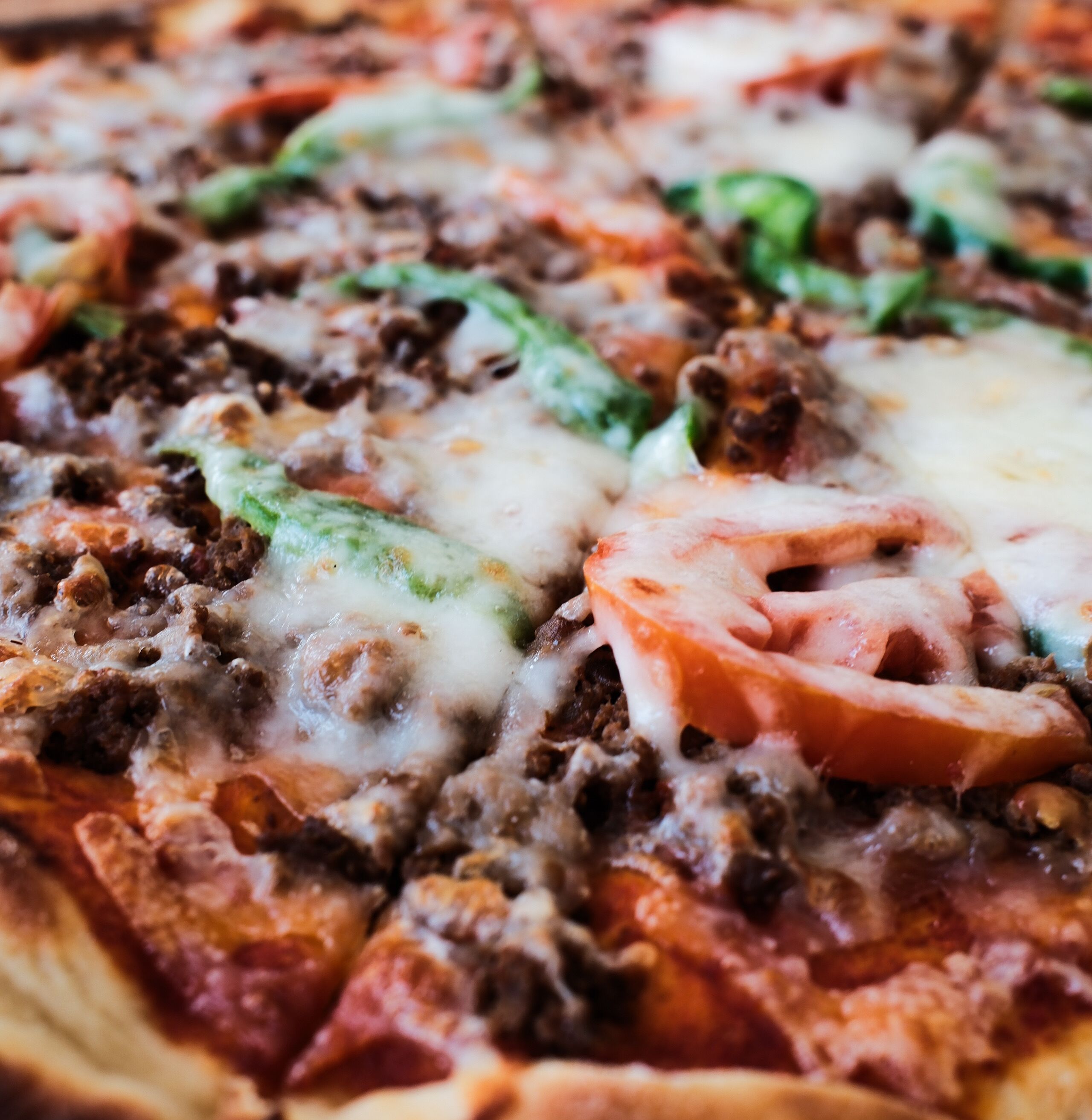 A close-up of a pizza with various toppings.