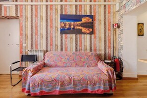 A room with a bed, a radiator, a chair, and a fire extinguisher. - Rome La Sapienza Apartment (Rome)