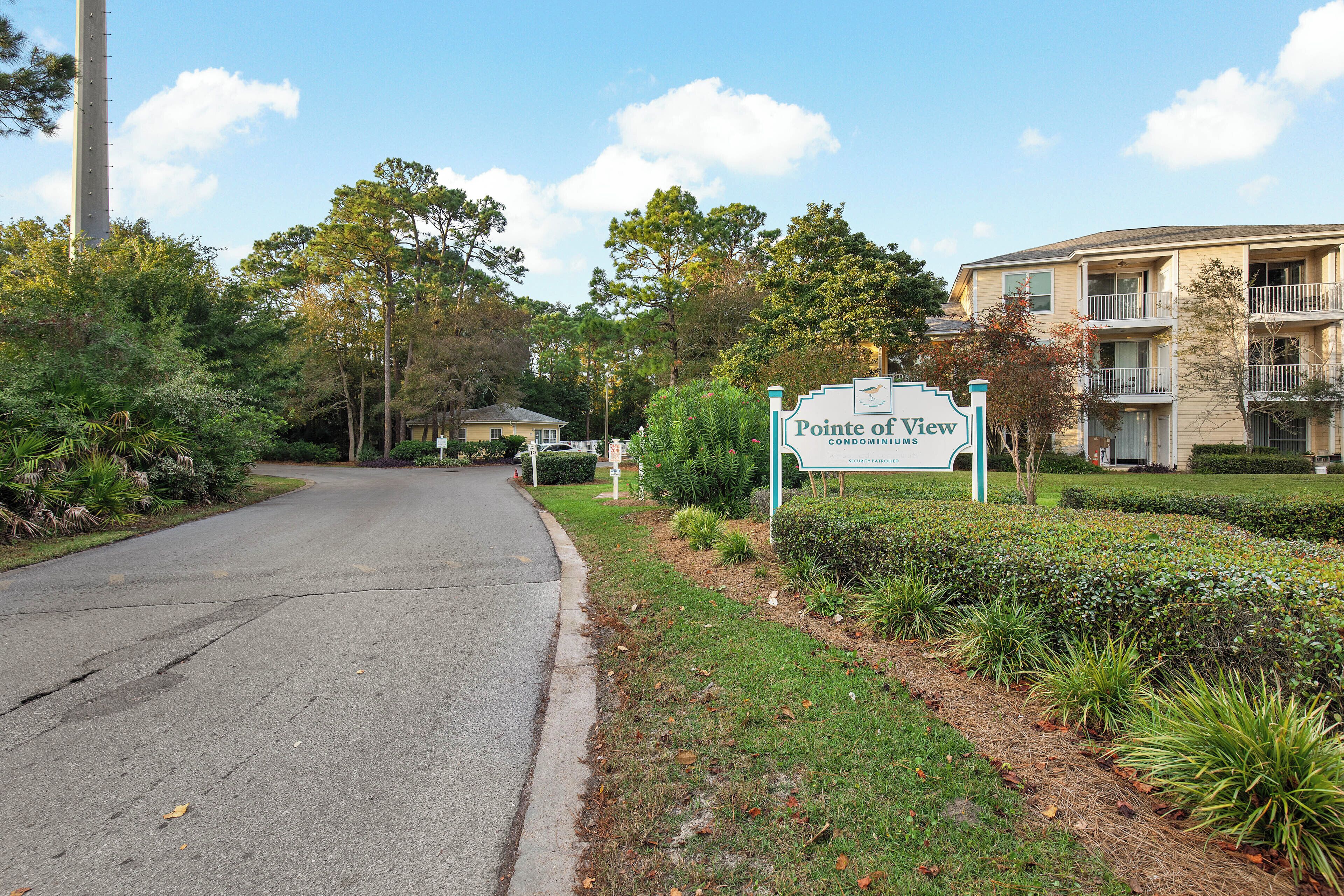 A residential area with a sign for Pointe of View Condominium.
