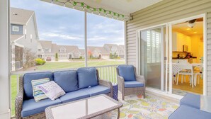 A covered porch with wicker furniture and a view of neighboring houses. - Shuttle to Beach: Millville Townhome w/ Porch (Millville)