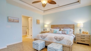 A bedroom with a large bed, two bedside tables, a ceiling fan, and a door leading to another room. - Shuttle to Beach: Millville Townhome w/ Porch (Millville)