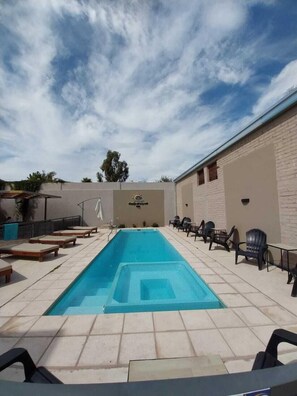 Outdoor pool, a heated pool, open 10:00 AM to 9:00 PM, free cabanas