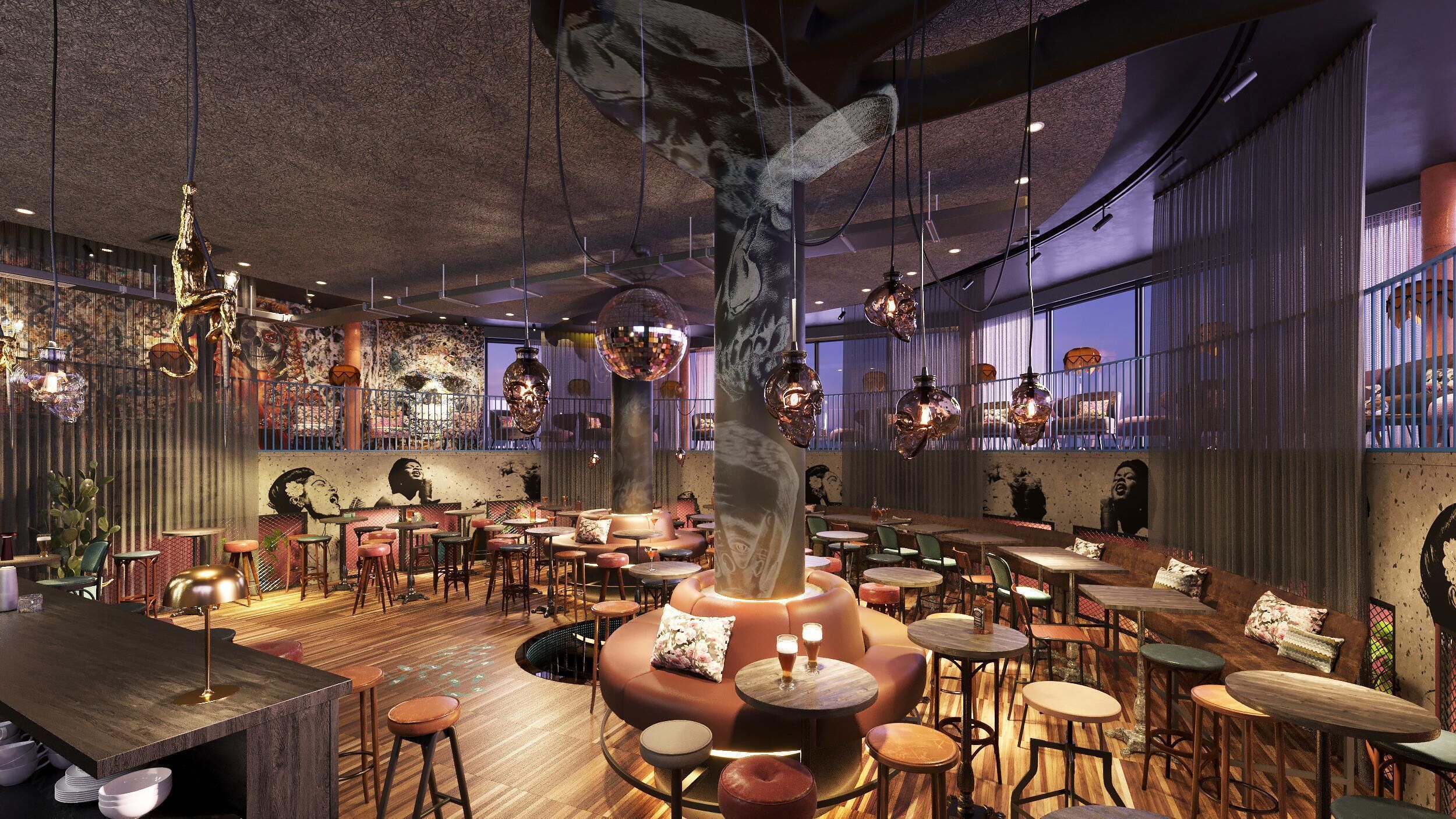 A restaurant interior with a central seating area, multiple tables and chairs, hanging decorative lights, and a mural on the walls.