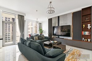 Deluxe Apartment | Living area | 85-inch Smart TV with cable channels, Netflix, streaming services - WelHome - 3BR Apt Located Directly on the Dubai Water Canal (Dubai)