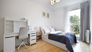 Ein Schlafzimmer mit einem Bett, einem Schreibtisch und einem Stuhl.