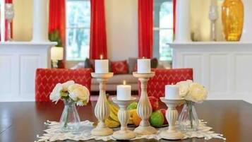 Enjoy a warm dinner setting with a beautifully set table, surrounded by elegant seating and a traditional atmosphere.