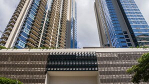 A modern building with a sign reading "SkyRenaissance Honolulu" and a clear sky with clouds. - Newly Built, Hottest Condo at "Sky Ala Moana" 10th Floor  1 Bedroom (SAW1005) (Honolulu)