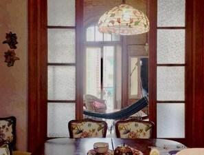 A dining area with a table, chairs, and a hammock. - Artist’s Oasis SanTelmo 2, comfy room for 1-2 people in spacious apt (Buenos Aires)