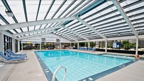 An indoor swimming pool with a covered roof, lounge chairs, and a clear view of the outside. - A Place At The Beach 369, Oceanside Condo in Atlantic Beach, NC! (Atlantic Beach)
