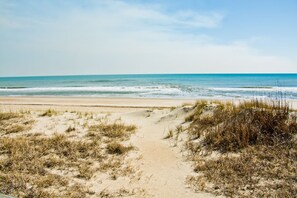 A sandy beach with a clear path leading to the ocean. - A Southern Exposure, Oceanfront House in Emerald Isle, NC! (Emerald Isle)