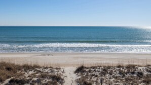 A beach with a clear view of the ocean, sandy dunes, and a wooden walkway leading to the water. - A Wave From it All, Oceanfront Duplex in Emerald Isle, NC! (Emerald Isle)