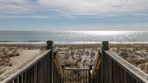 A wooden boardwalk leading to a beach with a clear view of the ocean and sky. - Angel's Dream, Oceanfront House in Emerald Isle, NC! (Emerald Isle)