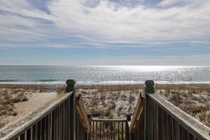 A wooden boardwalk leading to a beach with a clear view of the ocean and sky. - Angel's Dream, Oceanfront House in Emerald Isle, NC! (Emerald Isle)