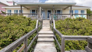 A wooden staircase leading to a two-story building with a porch. - Anniversary Waltz East, Oceanfront Duplex in Emerald Isle, NC! (Emerald Isle)