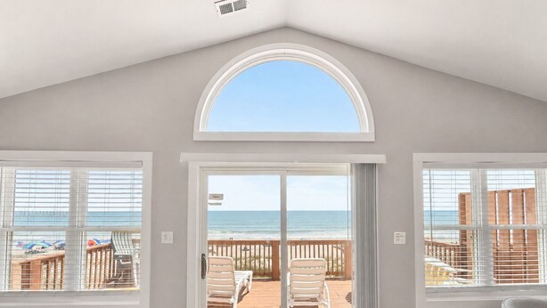 A room with a view of the beach, a sliding glass door, and a ceiling vent. - Atlantic Sea Oats, Oceanfront Duplex in Emerald Isle, NC! (Emerald Isle)