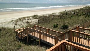 A wooden boardwalk leading to a beach with a view of the ocean and cloudy sky. - Atlantic Sea Oats, Oceanfront Duplex in Emerald Isle, NC! (Emerald Isle)